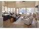 Bright living area with view of pool, stone fireplace, and comfortable seating arrangement at 7527 E Nestling Way, Scottsdale, AZ 85255