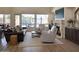Comfortable living room with fireplace, neutral furnishings, and outdoor pool views at 7527 E Nestling Way, Scottsdale, AZ 85255