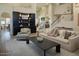 Spacious living room features a bar, open staircase and abundant natural light at 7527 E Nestling Way, Scottsdale, AZ 85255