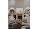 Cozy living room with a fireplace, comfortable seating, and stylish decor at 7527 E Nestling Way, Scottsdale, AZ 85255