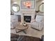 Cozy living room with a fireplace, comfortable seating, and decorative accents at 7527 E Nestling Way, Scottsdale, AZ 85255