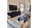 Stylish living room showcasing a large TV, custom built-ins, and modern furniture at 7527 E Nestling Way, Scottsdale, AZ 85255