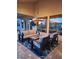 Chic patio space with comfortable seating, modern decor, and serene backyard views through large windows at 7527 E Nestling Way, Scottsdale, AZ 85255