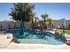 Backyard pool boasts a beach entry, a waterfall, and lush landscaping at 7527 E Nestling Way, Scottsdale, AZ 85255