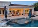 Inviting backyard featuring a sparkling pool, covered patio, comfortable seating, and lush landscaping at 7527 E Nestling Way, Scottsdale, AZ 85255