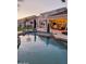 Enjoy the backyard oasis with custom pool, outdoor lounge, and covered patio at 7527 E Nestling Way, Scottsdale, AZ 85255