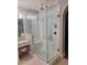 Stunning glass shower with a rainfall showerhead, seat, and decorative tile feature at 7527 E Nestling Way, Scottsdale, AZ 85255