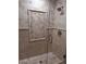 Glass shower showcasing neutral colored tiles and decorative accent panel at 7527 E Nestling Way, Scottsdale, AZ 85255