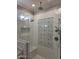 Shower showcasing decorative tile design, a rainfall showerhead, and convenient built-in shelf at 7527 E Nestling Way, Scottsdale, AZ 85255