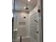 Luxurious shower featuring a rainfall showerhead, bench, and decorative tile inset at 7527 E Nestling Way, Scottsdale, AZ 85255