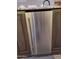 Stainless steel trash compactor providing convenient waste disposal and seamlessly integrated into the kitchen at 7527 E Nestling Way, Scottsdale, AZ 85255