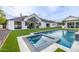 Expansive backyard featuring a sparkling pool and spa, lush landscaping, and covered patio for outdoor enjoyment at 7851 N Central Ave, Phoenix, AZ 85020