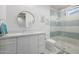 Bright bathroom featuring a round mirror, sleek vanity, and modern fixtures and glass shower at 7851 N Central Ave, Phoenix, AZ 85020