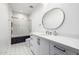Bathroom with honeycomb floor tiles, modern mirror and shower with gold trim at 7851 N Central Ave, Phoenix, AZ 85020