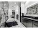 This bathroom features dual sinks, a soaking tub, walk-in closet, and sleek black and marble finishes at 7851 N Central Ave, Phoenix, AZ 85020
