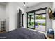 Relaxing bedroom with a comfortable bed and sliding glass doors that lead to the beautiful outdoor pool area at 7851 N Central Ave, Phoenix, AZ 85020