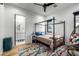 Cozy bedroom with a four-poster bed, colorful rug, and ensuite bathroom at 7851 N Central Ave, Phoenix, AZ 85020