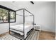 Bright bedroom features a four poster bed, black trim windows and light colored rug at 7851 N Central Ave, Phoenix, AZ 85020