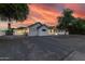 Stunning home exterior at dusk with manicured landscaping, a spacious driveway, and a warm, inviting ambiance at 7851 N Central Ave, Phoenix, AZ 85020