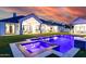 Exterior view of a home with a pool and hot tub with an orange sunset in the background at 7851 N Central Ave, Phoenix, AZ 85020