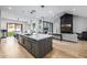 A modern open concept kitchen with a large island and stainless steel appliances with a view to the living room at 7851 N Central Ave, Phoenix, AZ 85020
