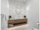 Stylish powder room featuring a unique vanity, modern lighting, and a decorative mirror for a touch of elegance at 7851 N Central Ave, Phoenix, AZ 85020