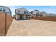 View of the backyard, enclosed by a brick fence and showcasing the back of the house with its covered patio at 8000 W Griswold Rd, Peoria, AZ 85345