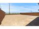 View of the backyard, enclosed by brick fence and showcasing a large dirt space ready for landscaping at 8000 W Griswold Rd, Peoria, AZ 85345