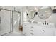 Bright bathroom featuring double sinks, modern fixtures, and a spacious glass-enclosed shower at 8000 W Griswold Rd, Peoria, AZ 85345