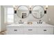 Elegant bathroom with a double vanity, sleek mirrors, and modern lighting fixtures for a luxurious space at 8000 W Griswold Rd, Peoria, AZ 85345