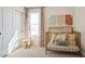 Adorable Bedroom featuring animal-themed artwork, a gold crib, and soft, patterned curtains for a sweet space at 8000 W Griswold Rd, Peoria, AZ 85345