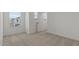 Bedroom featuring soft carpet, large windows, and convenient door to hallway at 8000 W Griswold Rd, Peoria, AZ 85345