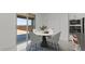 Cozy dining area near the kitchen featuring a modern round table with marble top and stylish chairs at 8000 W Griswold Rd, Peoria, AZ 85345