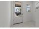 Bright entryway featuring a glass panel door and contemporary marble flooring at 8000 W Griswold Rd, Peoria, AZ 85345