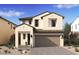 Charming two-story home with a desert landscaped yard and a two car garage and a neutral color palette at 8000 W Griswold Rd, Peoria, AZ 85345
