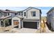 Lovely two-story home showcasing a stucco exterior, dark gray tiled roof and a two car garage at 8000 W Griswold Rd, Peoria, AZ 85345