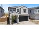 Charming two-story home featuring a stucco exterior, dark gray tiled roof and a lushly landscaped front yard at 8000 W Griswold Rd, Peoria, AZ 85345