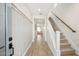 Bright hallway with wood floors, staircase, and natural light at 8000 W Griswold Rd, Peoria, AZ 85345