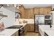 Modern kitchen featuring stainless steel appliances, stylish cabinetry, and open countertops at 8000 W Griswold Rd, Peoria, AZ 85345