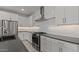 Beautiful kitchen featuring stainless steel appliances, gray countertops, white cabinets, and modern lighting at 8000 W Griswold Rd, Peoria, AZ 85345