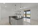 Stylish kitchen island featuring a sink and dishwasher, with modern pendant lighting and large tile flooring at 8000 W Griswold Rd, Peoria, AZ 85345