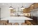 Well-appointed kitchen showcasing stainless steel appliances, wooden cabinetry, and an island with seating at 8000 W Griswold Rd, Peoria, AZ 85345