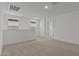 Spacious loft area with neutral carpet, recessed lighting, and a view of neighborhood homes at 8000 W Griswold Rd, Peoria, AZ 85345