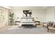 Stylish bedroom with a large window, modern art, and a comfortable seating area at 8024 W Griswold Rd, Peoria, AZ 85345