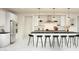 Modern kitchen featuring a large island with barstool seating, white cabinets, and stainless steel appliances at 8024 W Griswold Rd, Peoria, AZ 85345