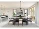 Bright, airy living room and dining area featuring modern furnishings, large windows, and sliding glass doors at 8024 W Griswold Rd, Peoria, AZ 85345
