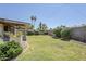 Lush backyard with mature landscaping, a covered patio, and potential for outdoor entertaining and relaxation at 8713 E Sage Dr, Scottsdale, AZ 85250