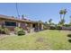 Spacious backyard with lush green grass, mature landscaping, and a covered patio perfect for outdoor living at 8713 E Sage Dr, Scottsdale, AZ 85250