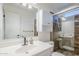 Bathroom featuring vanity with sink, toilet, and glass enclosed tiled shower at 8713 E Sage Dr, Scottsdale, AZ 85250