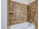 Tile shower and tub combination with shelves for storage and soap dish at 8713 E Sage Dr, Scottsdale, AZ 85250